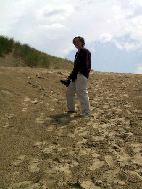 Jenn, barefoot in the sand.